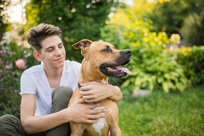 teenage boy with adopted dog